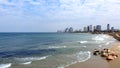 Morning city Tel Aviv. Blue sky and white clouds are reflected in the smooth surface of the Mediterranean Sea.