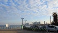 Morning city Tel Aviv. Blue sky and white clouds are reflected in the smooth surface of the Mediterranean Sea.