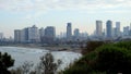 Morning city Tel Aviv. Blue sky and white clouds are reflected in the smooth surface of the Mediterranean Sea.