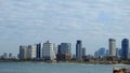 Morning city Tel Aviv. Blue sky and white clouds are reflected in the smooth surface of the Mediterranean Sea.