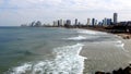 Morning city Tel Aviv. Blue sky and white clouds are reflected in the smooth surface of the Mediterranean Sea.