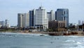 Morning city Tel Aviv. Blue sky and white clouds are reflected in the smooth surface of the Mediterranean Sea.