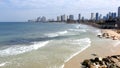 Morning city Tel Aviv. Blue sky and white clouds are reflected in the smooth surface of the Mediterranean Sea.