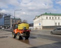 Morning cleaning of Moscow streets. The car pours water on the sidewalk.