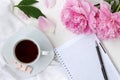 Morning coffee cup and notepad in bright colours with pink flowers Royalty Free Stock Photo