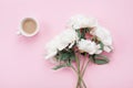 Morning coffee and beautiful white peony flowers on pink pastel table top view in flat lay style. Cozy breakfast for woman Royalty Free Stock Photo