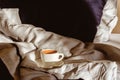 Morning coffee in bed. Cup of coffee on the bed. Enjoying the little things. Morning concept