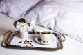 Morning coffee in bed on elegant silver serving tray