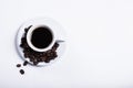 Inscription made of coffee beans on white background next to a cup of coffee Royalty Free Stock Photo