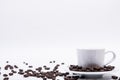 Inscription made of coffee beans on white background next to a cup of coffee Royalty Free Stock Photo