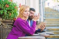 Morning coffee. Couple in love on romantic date. First meet of girl and mature man. Brutal hipster and girl drink coffee Royalty Free Stock Photo