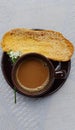 Morning coffee. A cup of coffe, bagelan breadand flower Royalty Free Stock Photo