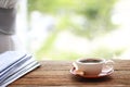 Morning coffee, Cup of coffee with newspapers, near the window.background in the morning sunlight. Royalty Free Stock Photo