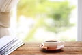 Morning coffee, Cup of coffee with newspapers, near the window.background in the morning sunlight. Royalty Free Stock Photo