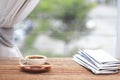 Morning coffee, Cup of coffee with newspapers, near the window.background in the morning sunlight. Royalty Free Stock Photo