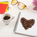 Morning coffee cup  notebook  pencil  glasses and flowers on white table. Top view  flat lay Royalty Free Stock Photo