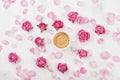 Morning coffee cup, petals and beautiful pink rose flowers on white stone background top view in flat lay style. Cozy breakfast Royalty Free Stock Photo