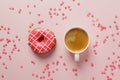 Morning coffee cup and sweet pastry of pink berry donut and heart shaped sprinkles on pink pastel table top view. Flat lay. Cozy Royalty Free Stock Photo