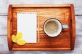 Morning coffee and empty notebook on wooden tray top view. Cozy autumn breakfast. Fall bucket list. Flat lay. Royalty Free Stock Photo