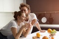 Morning coffee and gentle kissing feeding each other making fun at modern kitchen and smiling while cooking at home Royalty Free Stock Photo