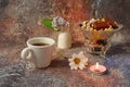 Morning coffee in a hurry: a cup of coffee, flowers in a vase, dried fruits and sweets in a vase, a burning candle Royalty Free Stock Photo