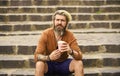 Morning coffee. man with cup outdoors. Handsome calm bearded man outdoors with coffee. drinking hot coffee. tourist