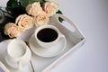 Morning coffee with milk on a white vintage tray and a bouquet of pink roses.Mother`s day concept.Flat lay.copy space