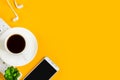 Morning coffee, notebook, mobile phone, plants, headphones on a yellow background. Copy space. Top view. Business yellow Royalty Free Stock Photo