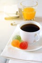 Morning coffee, orange juice, gummi candy and mobile phone Royalty Free Stock Photo