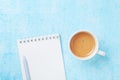 Morning coffee, pencil and clean notebook on blue pastel table top view. Flat lay style. Planning and design concept for blogging.