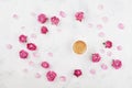 Morning coffee, petals and beautiful pink rose flowers on white stone table top view in flat lay style. Cozy breakfast. Royalty Free Stock Photo