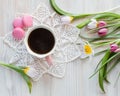 Morning coffee in pink cup, vintage napkin. Fresh garden pink and white tulips Royalty Free Stock Photo