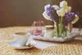 Morning coffee, spring decorations at home on the table in modern scandinavian style with flowers and aromatic candles Royalty Free Stock Photo