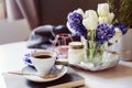 Morning coffee, spring decorations at home on the table in modern scandinavian style with flowers and aromatic candles Royalty Free Stock Photo