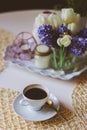 Morning coffee, spring decorations at home on the table in modern scandinavian style with flowers and aromatic candles Royalty Free Stock Photo