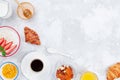 Morning continental breakfast with coffee, croissant, oatmeal, jam, honey and juice on stone table top view. Flat lay style.