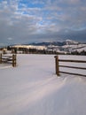 Morning countryside hills, groves and farmlands in winter remote alpine mountain village Royalty Free Stock Photo