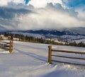 Morning countryside hills, groves and farmlands in winter remote alpine mountain village Royalty Free Stock Photo