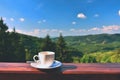 Morning cup of coffee with a beautiful mountain landscape background. Relaxation and recreation on vacation. Royalty Free Stock Photo