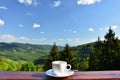 Morning cup of coffee with a beautiful mountain landscape background. Relaxation and recreation on vacation. Royalty Free Stock Photo