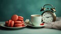 A morning cup of coffee, macaron cakes, and a nostalgic vintage alarm clock