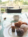 Morning cup of coffee with selection of cakes.