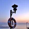 Morning dawn. seascape. lantern with lifebuoy