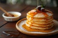 Morning delight Pancakes drizzled with honey on wooden surface