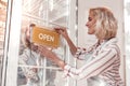 Delighted attractive woman standing near the door Royalty Free Stock Photo