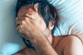 Morning depression and midlife crisis with man in bed Royalty Free Stock Photo