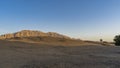 Morning in the desert. A bright balloon rises above the sand dunes. Royalty Free Stock Photo