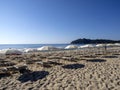 Morning empty beach with parasols, Sardinia, Italy Royalty Free Stock Photo