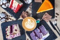 Top view on colorful cake with coffe on white table. Different dessrts. Royalty Free Stock Photo