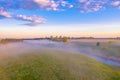 Morning fog in the meadows and at the mouth of the river during sunrise in the countryside, view from the height of the landscape Royalty Free Stock Photo